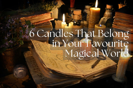flatlay of a magic book surrounded by candles